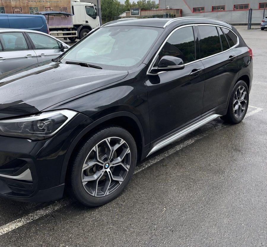 BMW X1 noire après réparation de carrosserie chez SG Carrosserie
